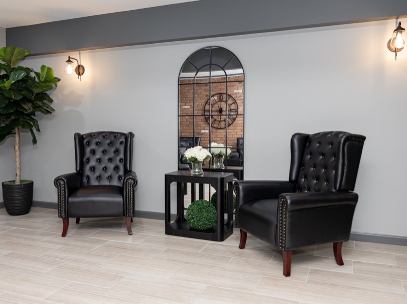 Twin wing chairs and arched mirror